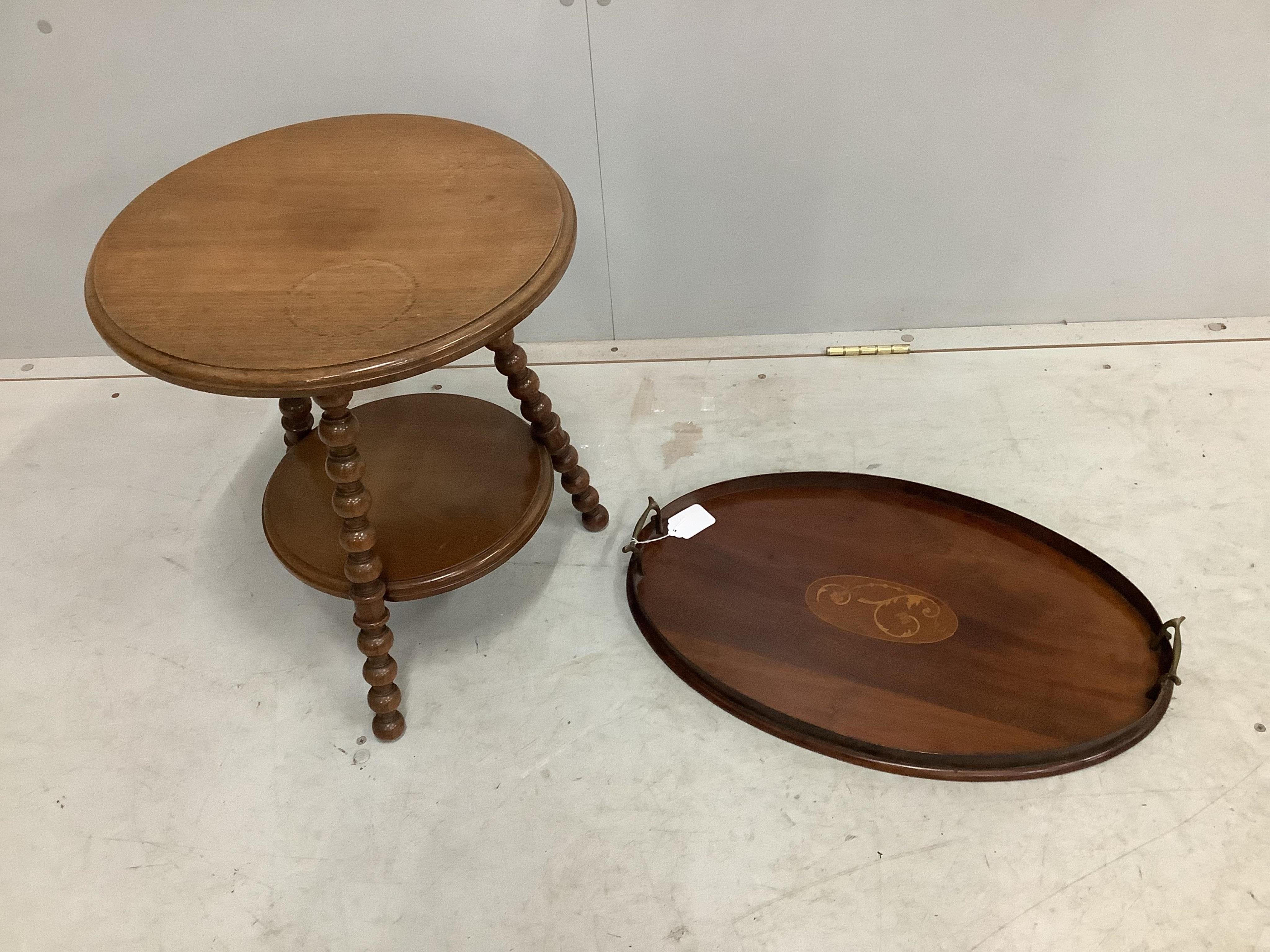 An Edwardian oval mahogany inlaid tea tray, width 55cm, and a late Victorian bobbin turned circular two tier occasional table. Condition - fair